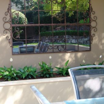 Feature mirror on outdoor wall